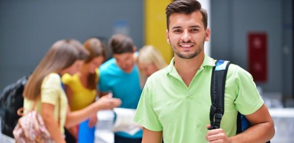 Smiling Student Holding Knapsack
