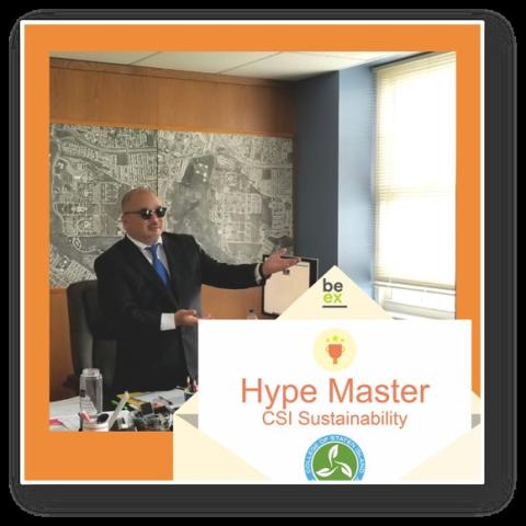 Hype Master Award Kenichi Iwama VP of Economic Development wearing sunglasses with the shades closed in his office.