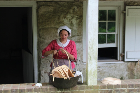 A woman holding a basket in Historic Richmond Town A woman holding a basket in Historic Richmond Town