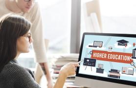 two students looking at PC monitor