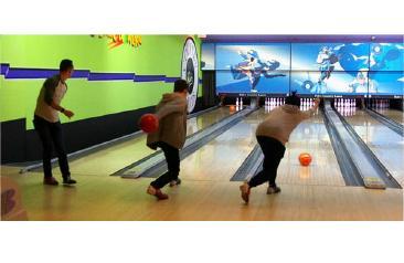 Three School of Business students bowling Three students bowling