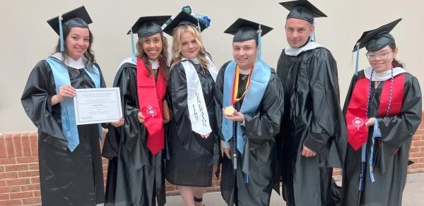A group of students wearing commencement regalia