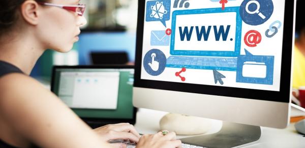 female student looking at monitor of PC