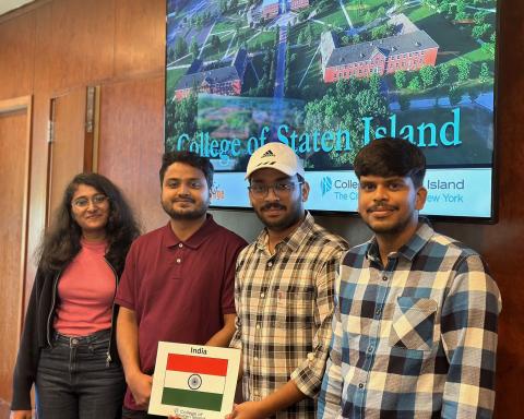Four Students With a Picture of the Flag of India Four Students With a Picture of the Flag of India